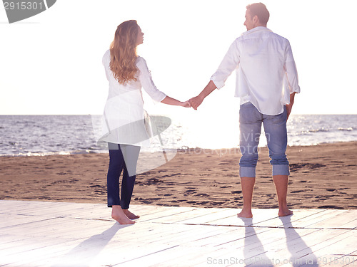 Image of young couple  on beach have fun