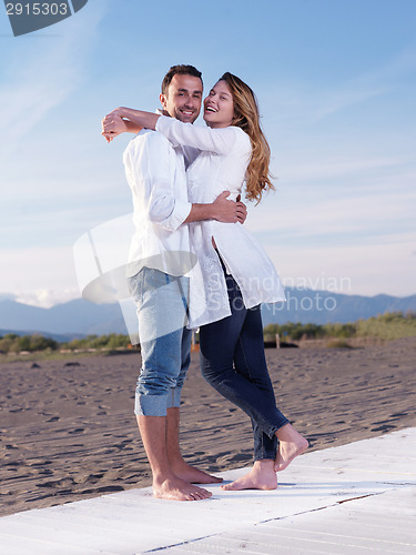 Image of young couple  on beach have fun