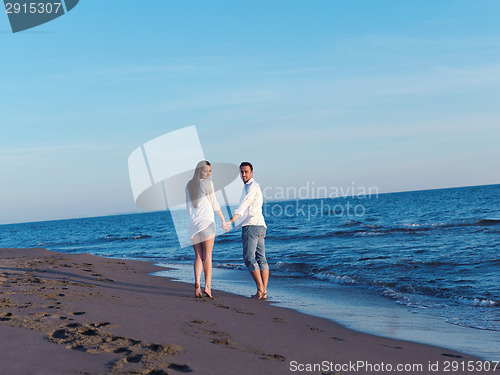 Image of young couple  on beach have fun