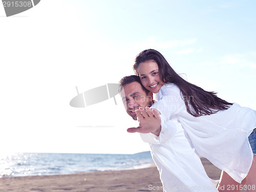 Image of young couple  on beach have fun
