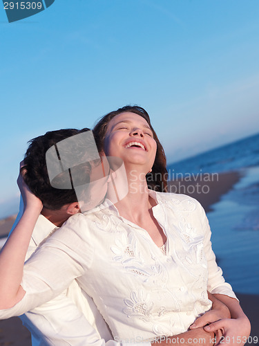Image of young couple  on beach have fun