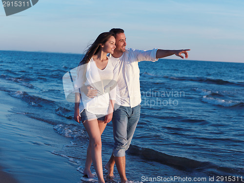 Image of young couple  on beach have fun