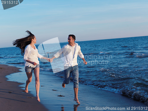 Image of young couple  on beach have fun