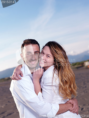 Image of young couple  on beach have fun
