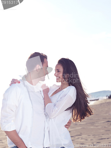 Image of young couple  on beach have fun