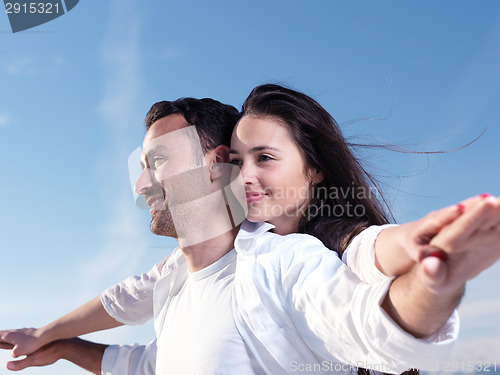 Image of young couple  on beach have fun