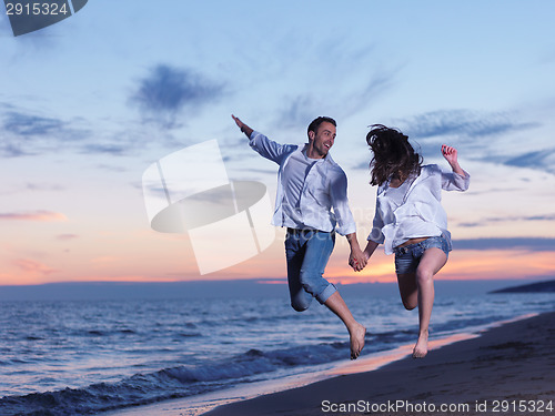 Image of young couple  on beach have fun