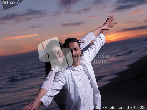 Image of young couple  on beach have fun