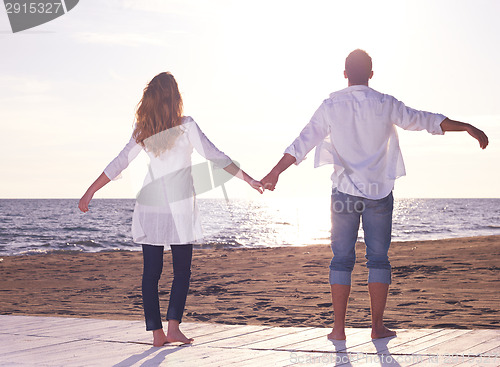Image of young couple  on beach have fun