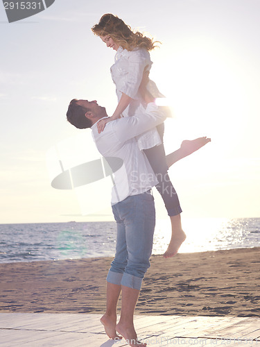 Image of young couple  on beach have fun