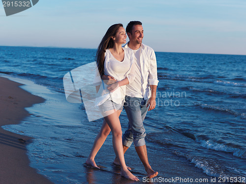 Image of young couple  on beach have fun