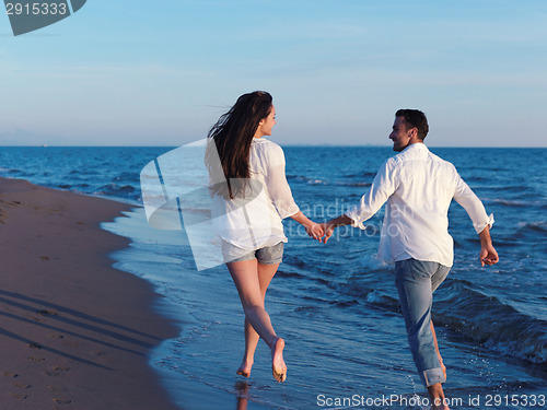 Image of young couple  on beach have fun