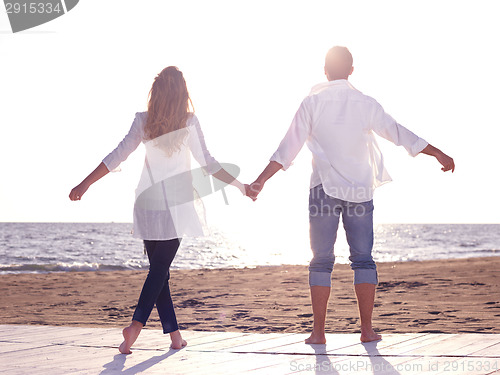 Image of young couple  on beach have fun