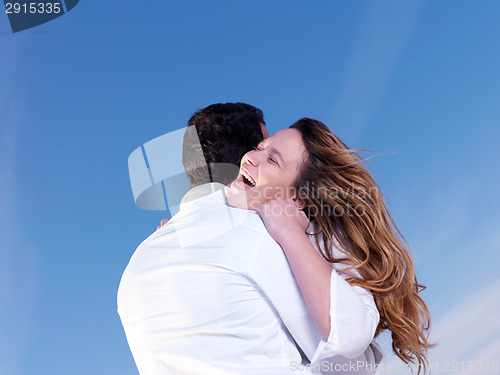 Image of young couple  on beach have fun