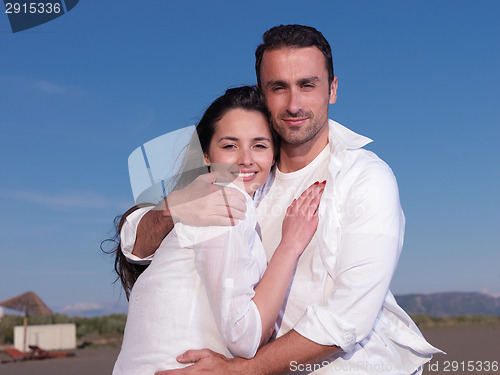 Image of young couple  on beach have fun