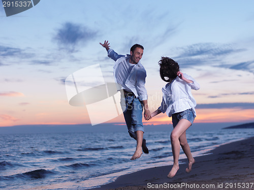 Image of young couple  on beach have fun