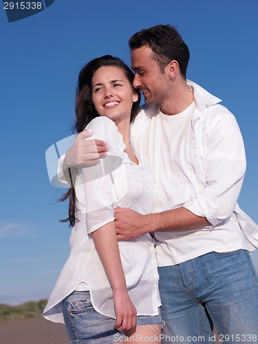 Image of young couple  on beach have fun