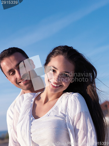 Image of young couple  on beach have fun