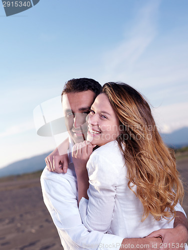 Image of young couple  on beach have fun