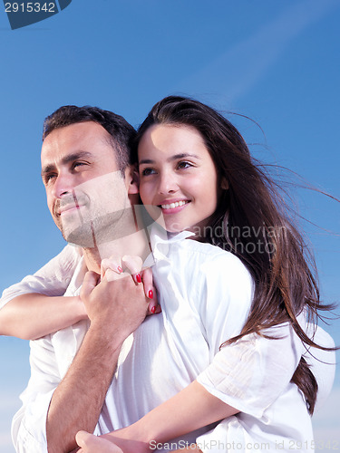 Image of young couple  on beach have fun