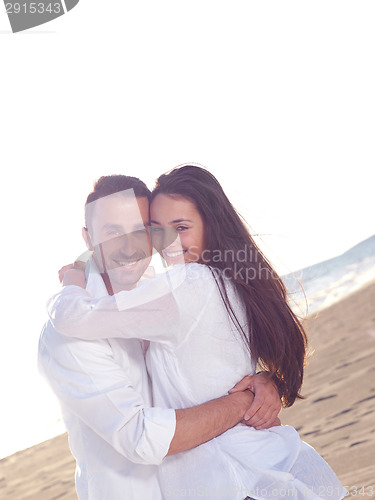 Image of young couple  on beach have fun