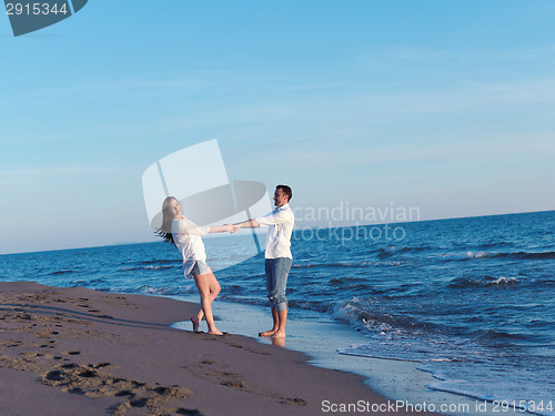 Image of young couple  on beach have fun