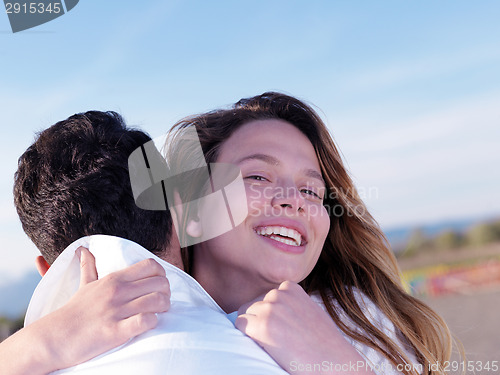 Image of young couple  on beach have fun