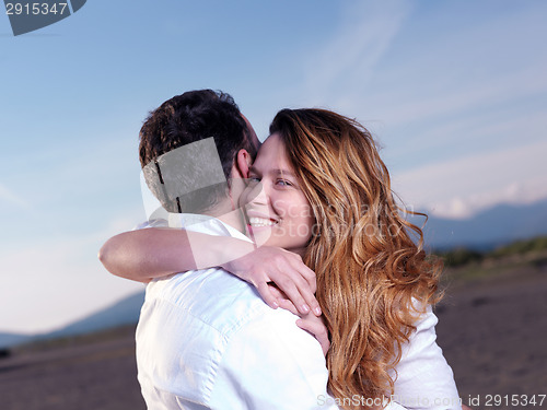 Image of young couple  on beach have fun