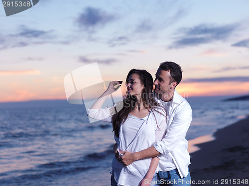 Image of young couple  on beach have fun