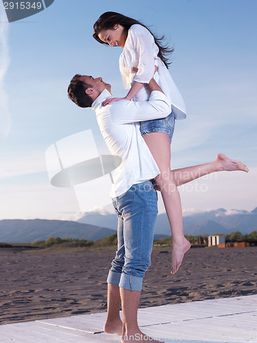 Image of young couple  on beach have fun