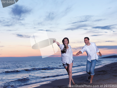 Image of young couple  on beach have fun