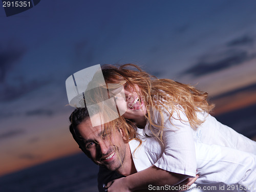 Image of young couple  on beach have fun