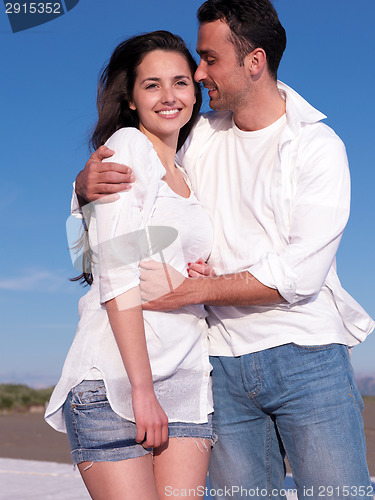 Image of young couple  on beach have fun
