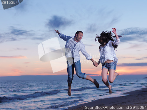 Image of young couple  on beach have fun