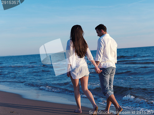 Image of young couple  on beach have fun