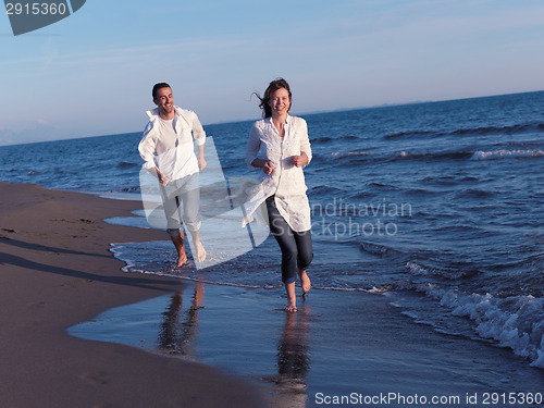 Image of young couple  on beach have fun