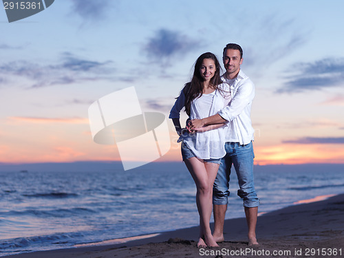 Image of young couple  on beach have fun