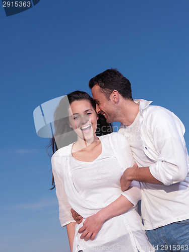 Image of young couple  on beach have fun