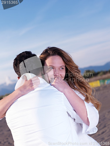 Image of young couple  on beach have fun