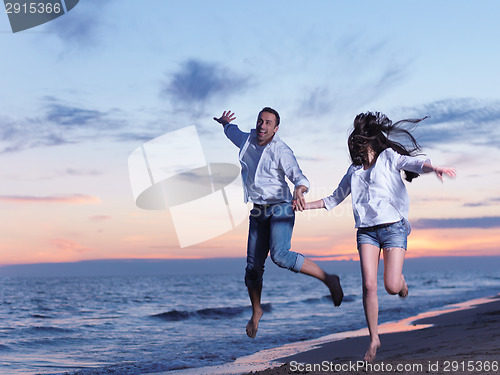 Image of young couple  on beach have fun