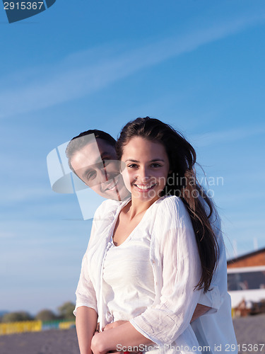 Image of young couple  on beach have fun
