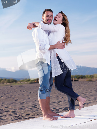 Image of young couple  on beach have fun