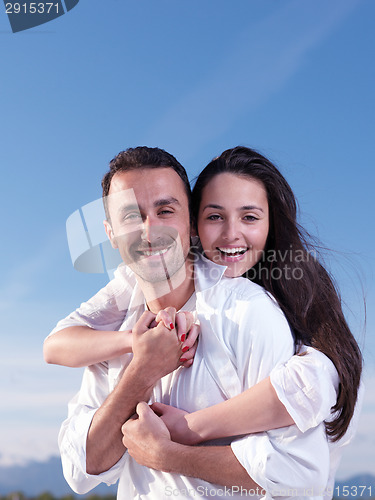 Image of young couple  on beach have fun