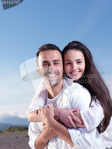 Image of young couple  on beach have fun