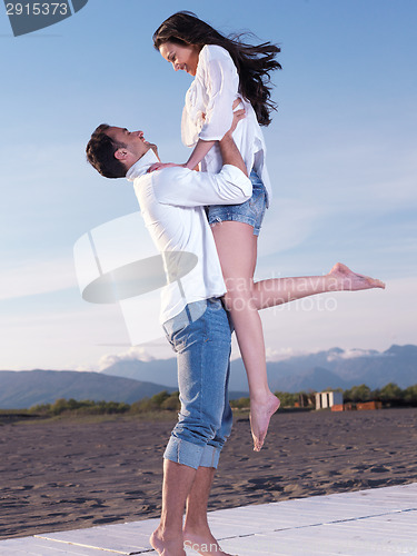 Image of young couple  on beach have fun