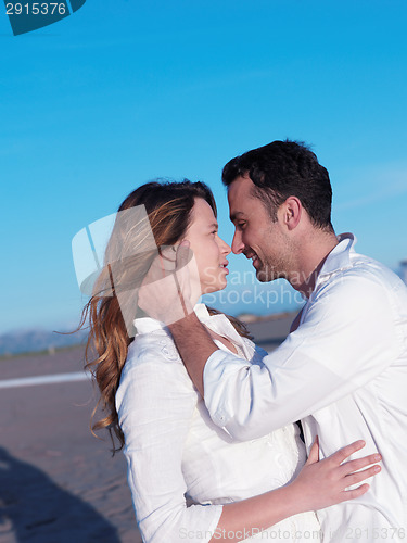 Image of young couple  on beach have fun