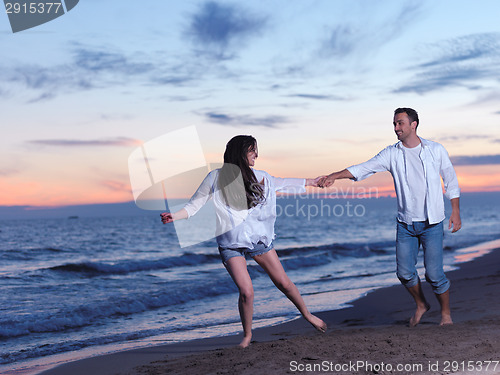 Image of young couple  on beach have fun