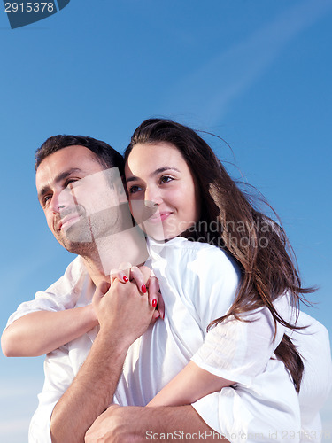 Image of young couple  on beach have fun