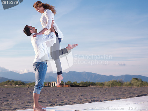 Image of young couple  on beach have fun