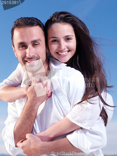 Image of young couple  on beach have fun